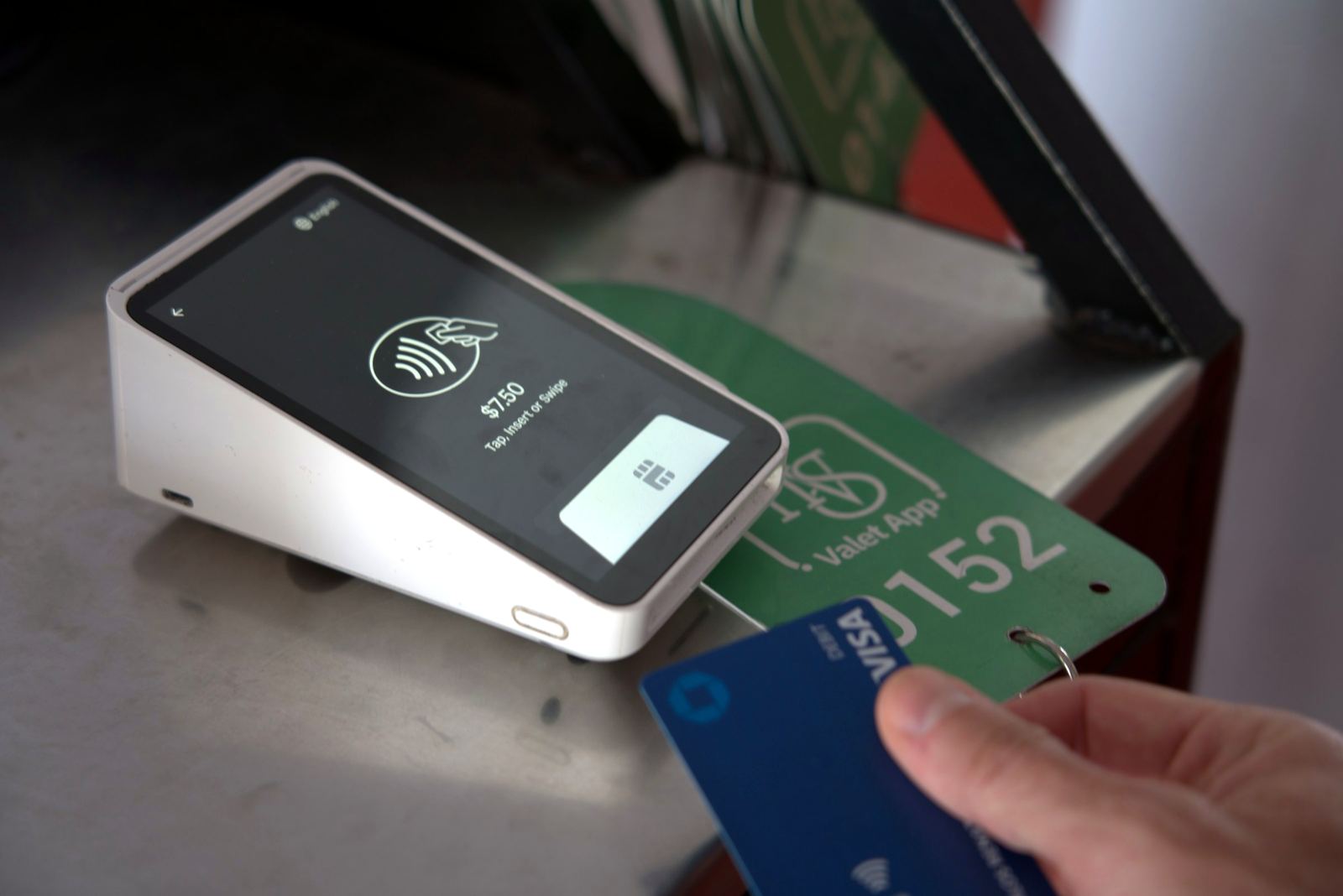 Guest paying for valet parking by card at an HVS payment terminal