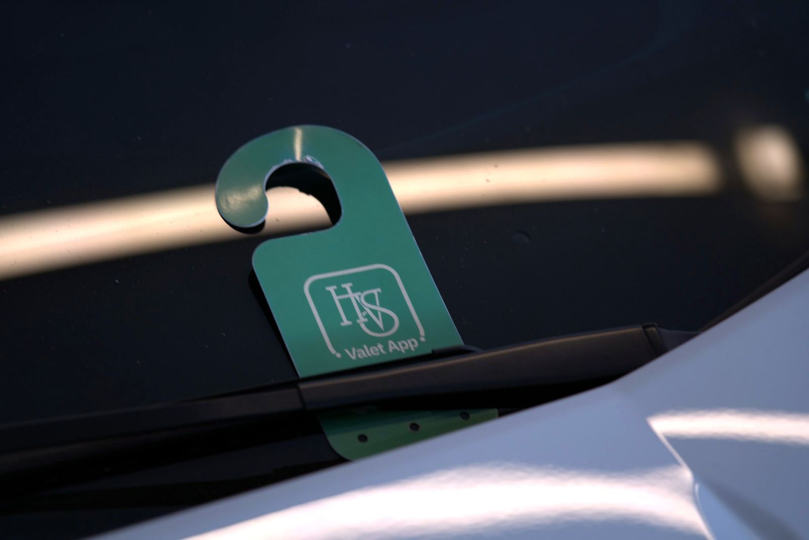 HVS Valet App tag displayed in a parked car's windshield