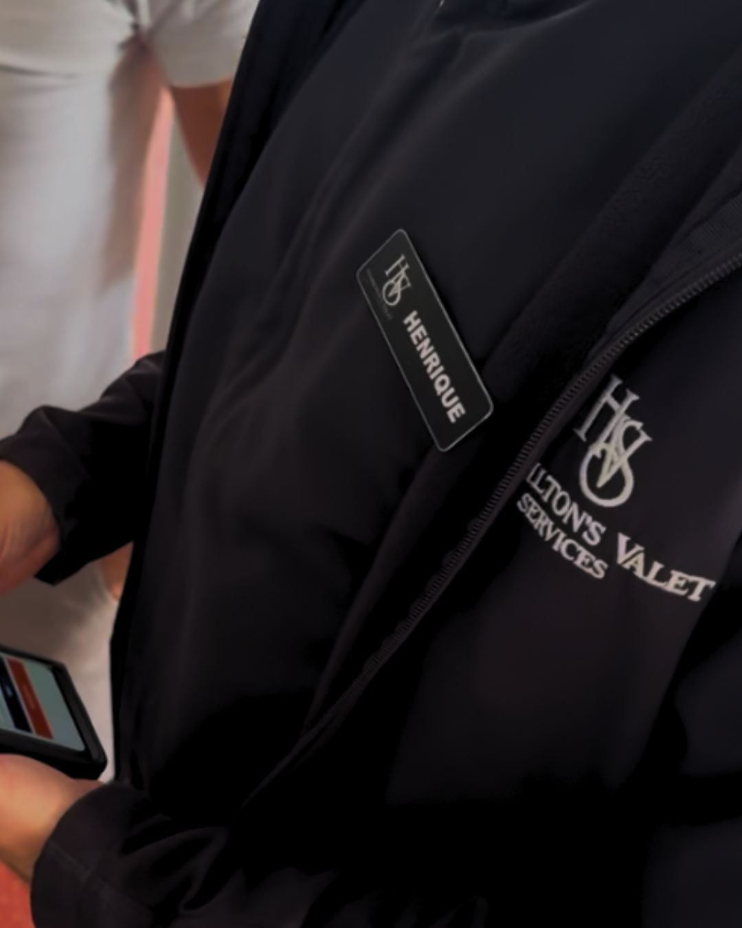 Black Hamilton's Valet Services uniform with the HVS logo and name badge